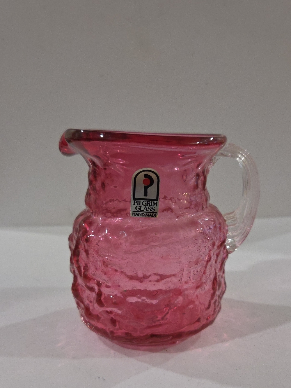 Pilgrim Pink Textured Handblown Glass Pitcher with Clear Handle